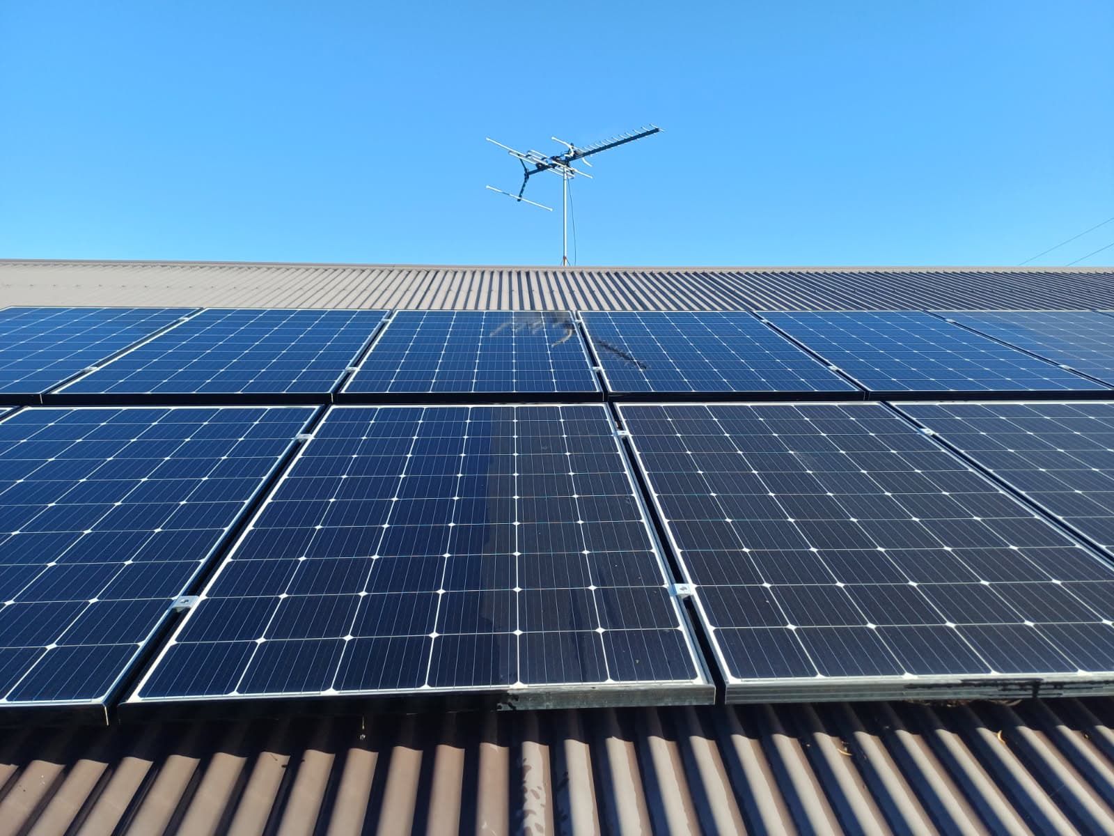 Clean solar panels on corrugated iron roof in Gladstone Region